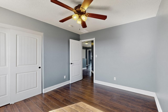 1324 Desert Paintbrush Loop, Rio Rancho, NM 87144 - unfurnished bedroom featuring dark wood-type flooring, ceiling fan, and a closet