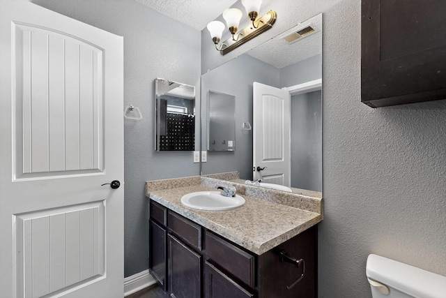 1324 Desert Paintbrush Loop, Rio Rancho, NM 87144 - bathroom with vanity and a textured ceiling