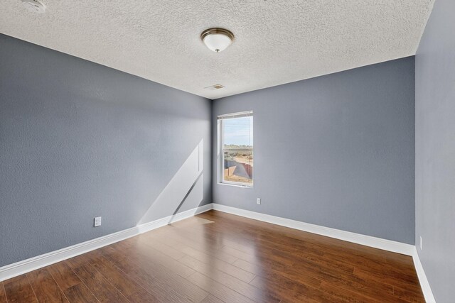 1324 Desert Paintbrush Loop, Rio Rancho, NM 87144 - unfurnished room featuring wood finished floors and a textured ceiling