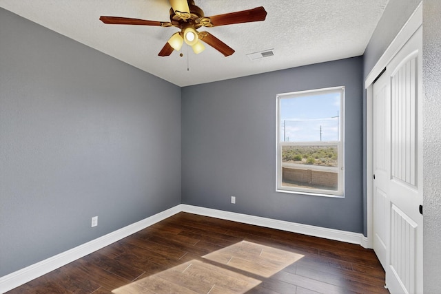 1324 Desert Paintbrush Loop, Rio Rancho, NM 87144 - unfurnished bedroom featuring dark wood-style floors, a closet, and ceiling fan