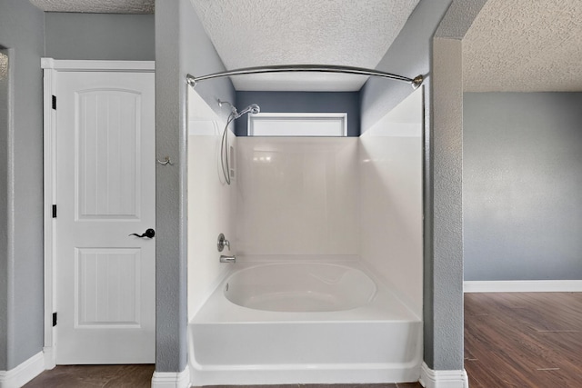 1324 Desert Paintbrush Loop, Rio Rancho, NM 87144 - full bath featuring a textured ceiling, shower / bath combination, and wood finished floors