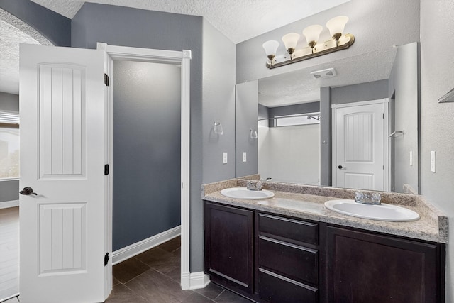 1324 Desert Paintbrush Loop, Rio Rancho, NM 87144 - full bathroom with a textured ceiling and double vanity