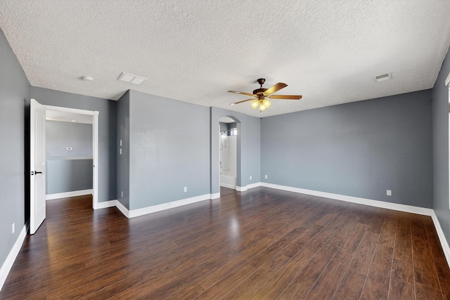 1324 Desert Paintbrush Loop, Rio Rancho, NM 87144 - unfurnished room featuring a ceiling fan, dark wood-type flooring, a textured ceiling, and arched walkways
