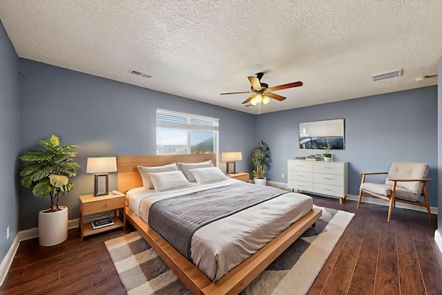 1324 Desert Paintbrush Loop, Rio Rancho, NM 87144 - bedroom with dark wood-type flooring, a ceiling fan, and a textured ceiling