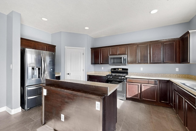1324 Desert Paintbrush Loop, Rio Rancho, NM 87144 - kitchen featuring appliances with stainless steel finishes, a kitchen island, dark brown cabinetry, and recessed lighting