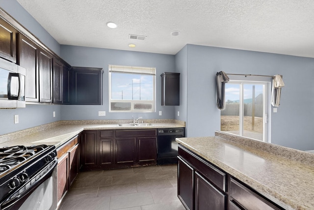 1324 Desert Paintbrush Loop, Rio Rancho, NM 87144 - kitchen featuring a textured ceiling, black appliances, light countertops, and healthy amount of natural light