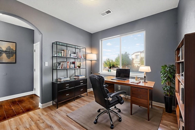1324 Desert Paintbrush Loop, Rio Rancho, NM 87144 - home office featuring light wood finished floors and arched walkways