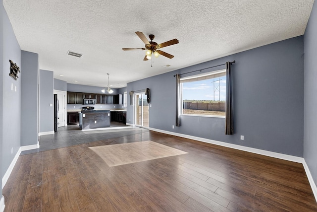 1324 Desert Paintbrush Loop, Rio Rancho, NM 87144 - unfurnished living room with ceiling fan, dark wood-style flooring, and a textured ceiling