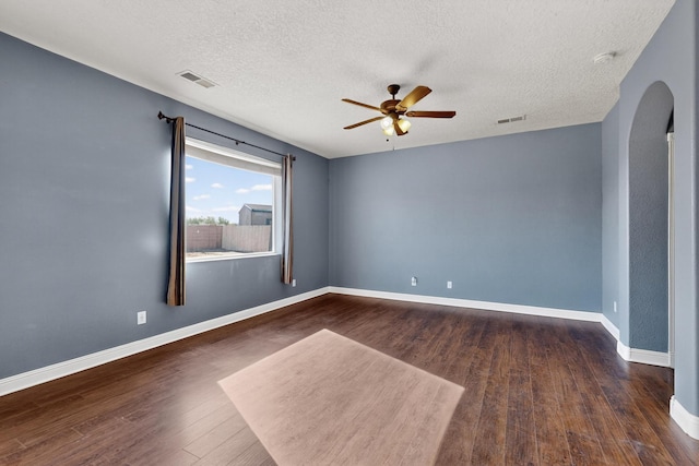 1324 Desert Paintbrush Loop, Rio Rancho, NM 87144 - empty room with a ceiling fan, wood finished floors, arched walkways, and a textured ceiling