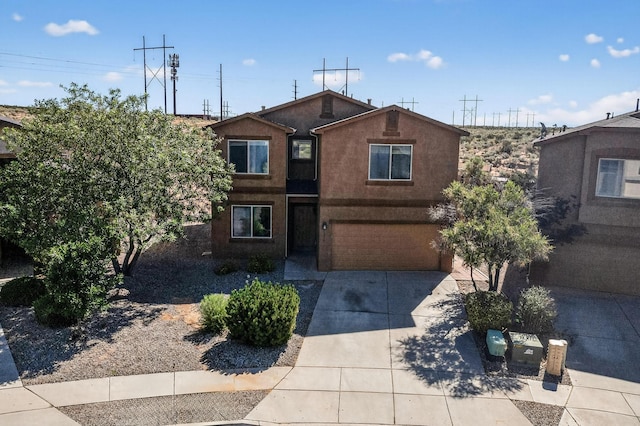 1324 Desert Paintbrush Loop, Rio Rancho, NM 87144 - view of front of home with concrete driveway, a garage, and stucco siding