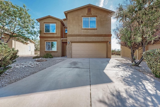 1324 Desert Paintbrush Loop, Rio Rancho, NM 87144 - view of front of house with stucco siding, driveway, and a garage