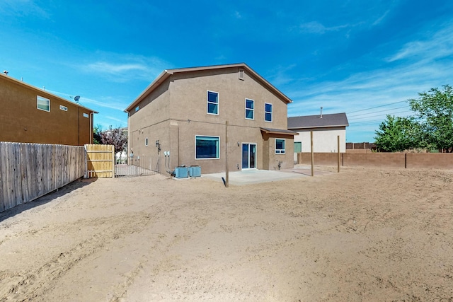 1324 Desert Paintbrush Loop, Rio Rancho, NM 87144 - back of property with stucco siding, a patio, and a fenced backyard