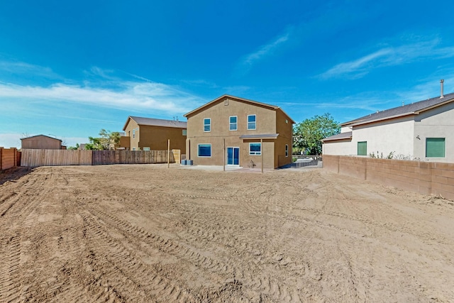 1324 Desert Paintbrush Loop, Rio Rancho, NM 87144 - back of property featuring a fenced backyard and stucco siding