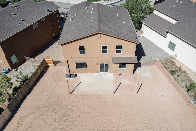 1324 Desert Paintbrush Loop, Rio Rancho, NM 87144 - back of property with a patio area, a fenced backyard, stucco siding, and a shingled roof