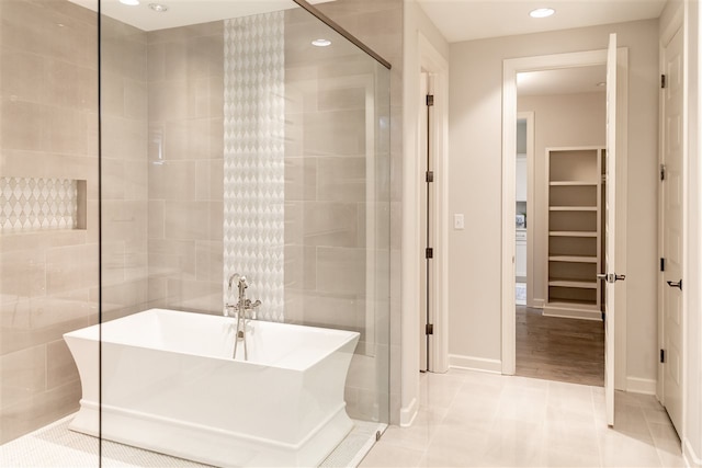 bathroom featuring tile patterned floors and a bathtub