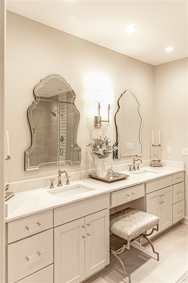 bathroom with a shower, vanity, and tile patterned floors