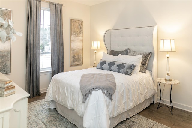 bedroom featuring multiple windows and hardwood / wood-style flooring