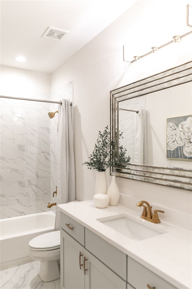 9636 Grays Meadow Dr, Cordova, TN 38018 - full bathroom featuring vanity, visible vents, toilet, marble finish floor, and shower / tub combo with curtain