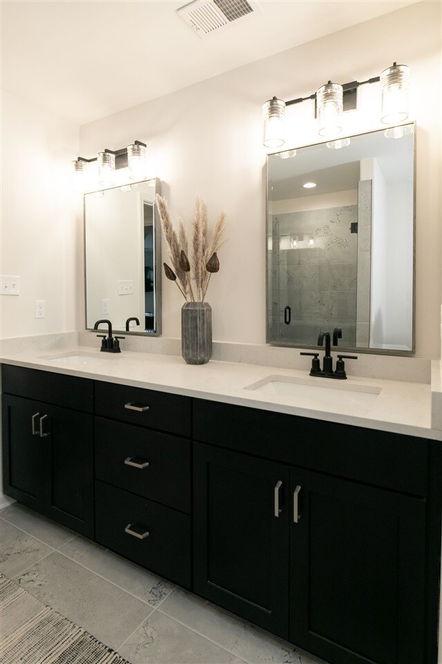 9636 Grays Meadow Dr, Cordova, TN 38018 - full bathroom with double vanity, visible vents, a sink, and a stall shower