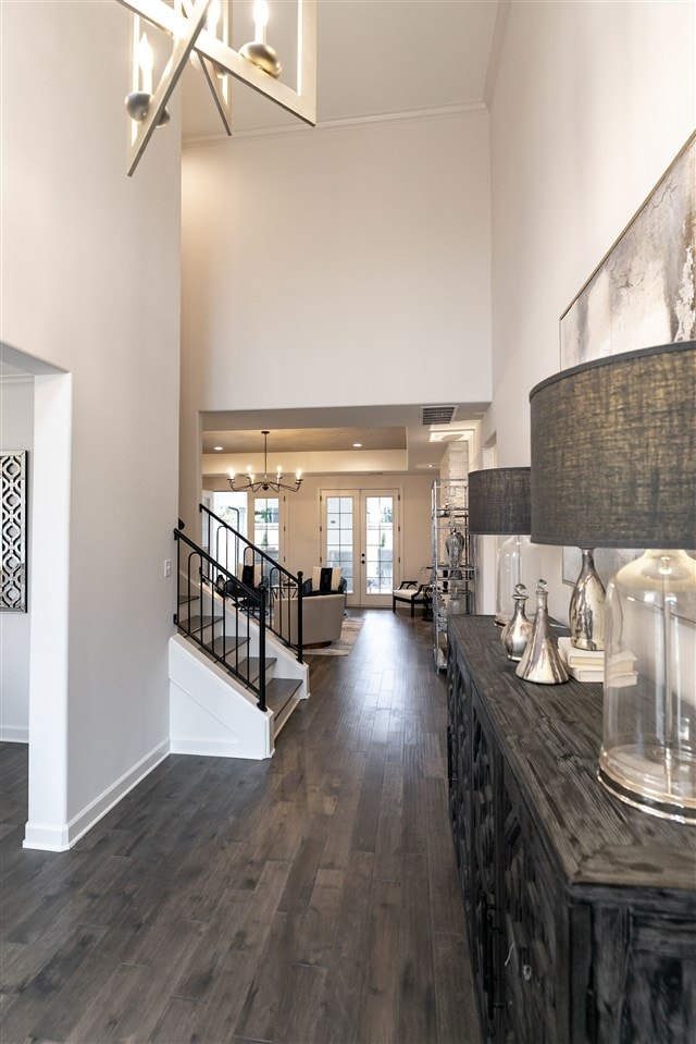 9636 Grays Meadow Dr, Cordova, TN 38018 - entrance foyer with baseboards, a high ceiling, a notable chandelier, stairway, and dark wood-type flooring