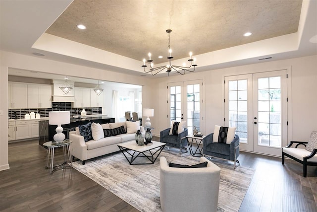 9636 Grays Meadow Dr, Cordova, TN 38018 - living room with dark wood-style flooring, a chandelier, french doors, visible vents, and a raised ceiling