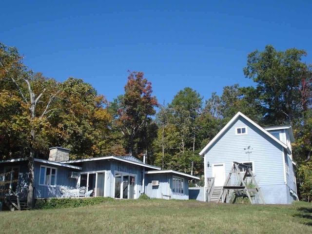 back of property featuring a yard