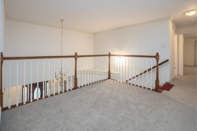 hallway with crown molding and carpet flooring