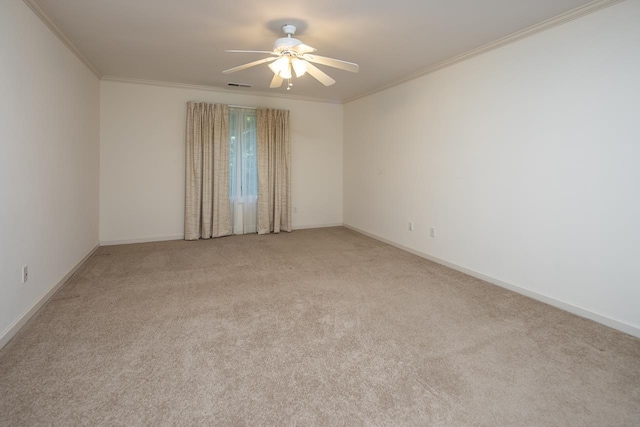 empty room with ceiling fan, light colored carpet, and ornamental molding