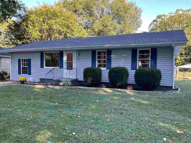 ranch-style home with a front lawn