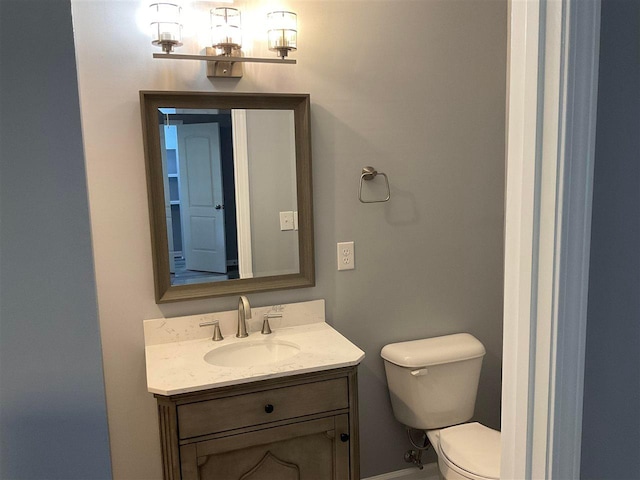 bathroom with toilet and vanity