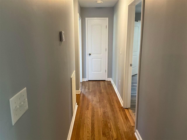 hall with dark hardwood / wood-style flooring