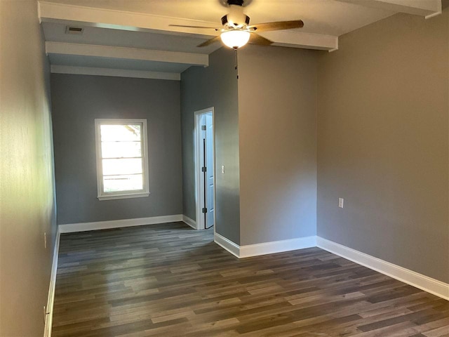 spare room with beam ceiling, dark hardwood / wood-style floors, and ceiling fan