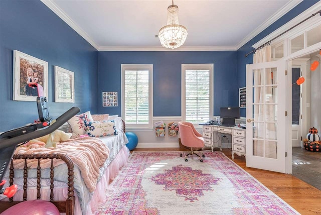 bedroom featuring ornamental molding, a chandelier, french doors, and light wood-type flooring