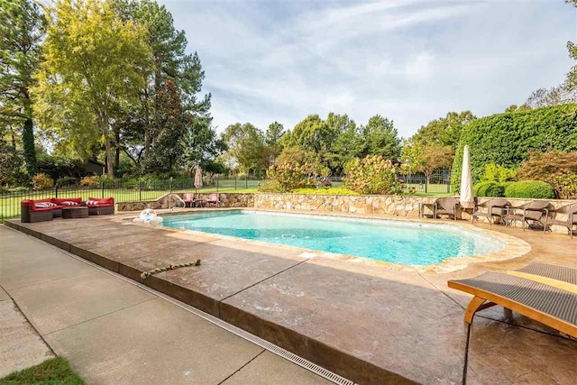 view of swimming pool with a patio area