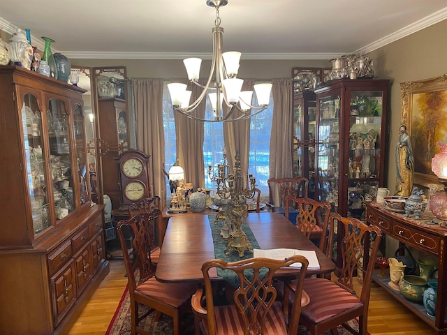 245 S Mendenhall Rd, Memphis, TN 38117 - dining area with a notable chandelier, ornamental molding, and light hardwood / wood-style floors