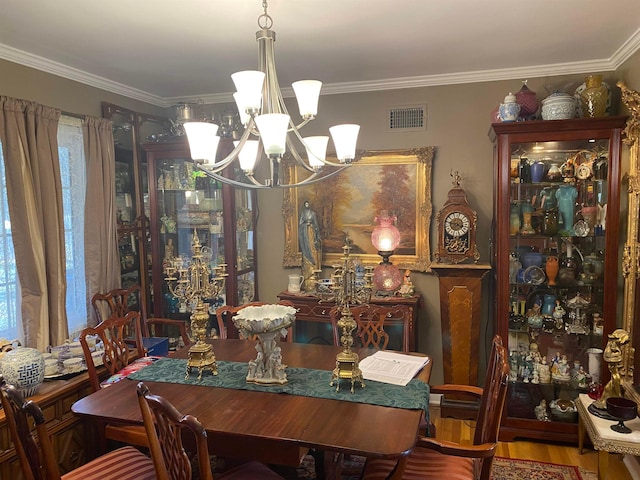 245 S Mendenhall Rd, Memphis, TN 38117 - dining space featuring crown molding, a chandelier, and wood-type flooring