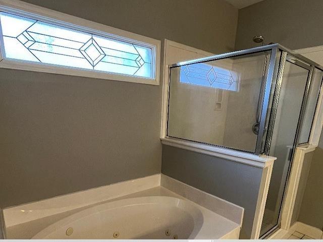 bathroom with shower with separate bathtub