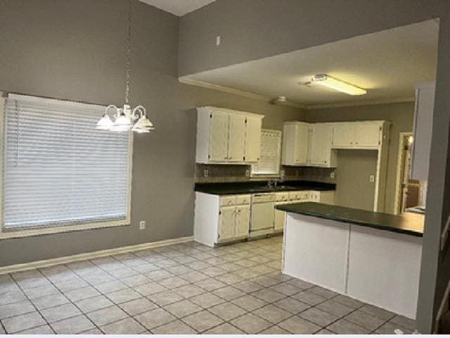 kitchen featuring white cabinetry, decorative light fixtures, light tile flooring, a notable chandelier, and tasteful backsplash