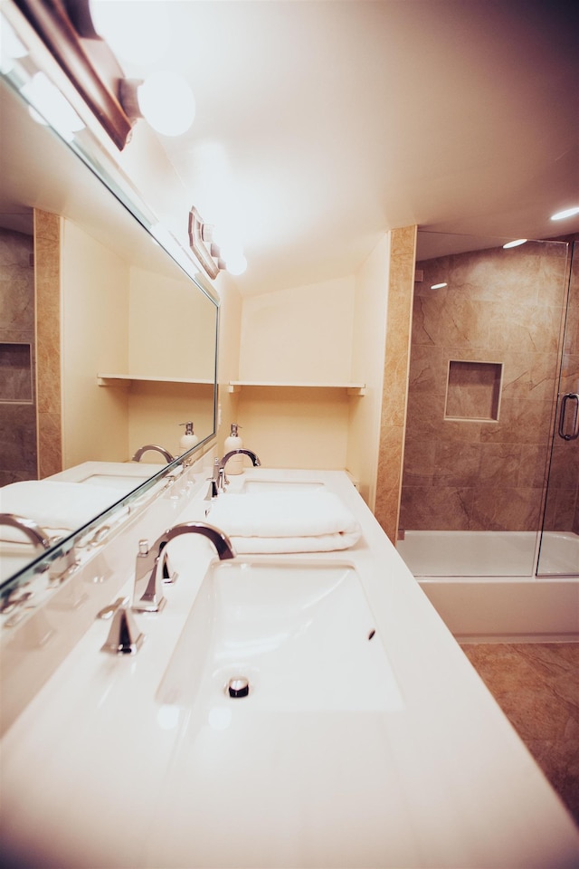 bathroom featuring dual sinks, tile flooring, a shower with door, and vanity with extensive cabinet space