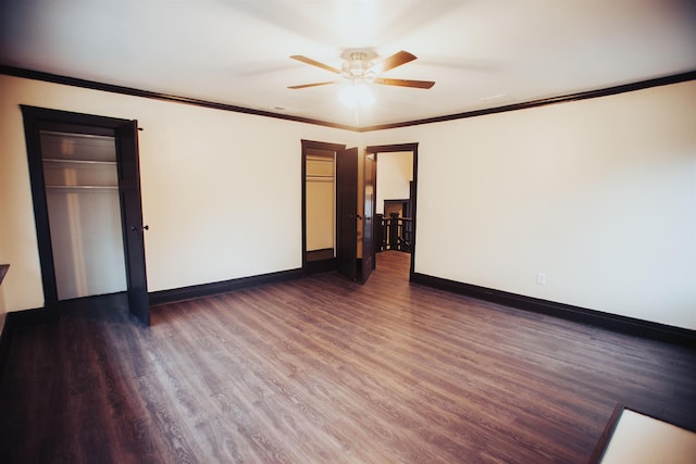 unfurnished room with ceiling fan, dark wood-type flooring, and ornamental molding