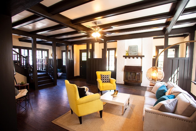 living room with dark hardwood / wood-style flooring, beam ceiling, and plenty of natural light