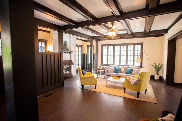 living room featuring plenty of natural light, dark hardwood / wood-style floors, beam ceiling, and ceiling fan