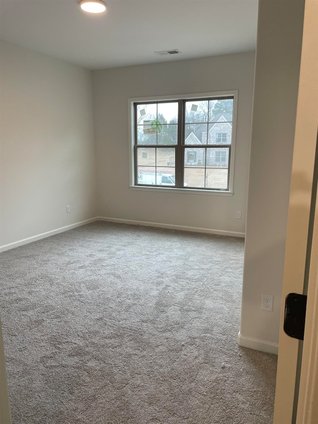 spare room with light carpet