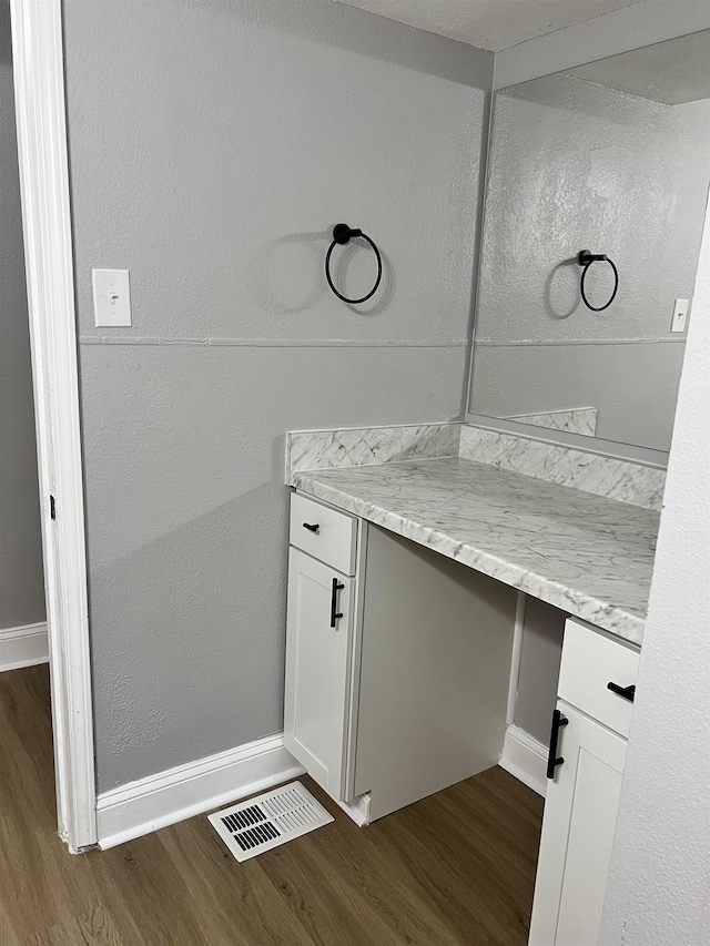 bathroom with hardwood / wood-style floors and vanity