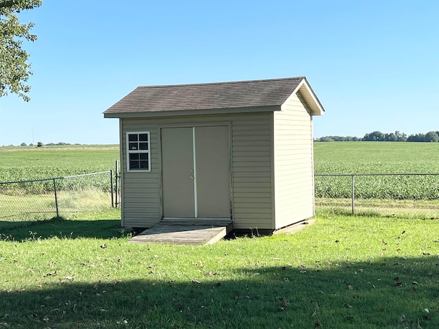 view of shed / structure featuring a rural view and a lawn