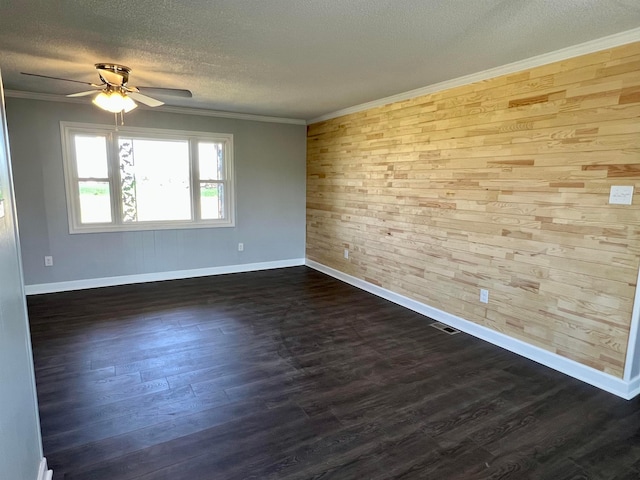 unfurnished room with wooden walls, ceiling fan, ornamental molding, and dark hardwood / wood-style flooring