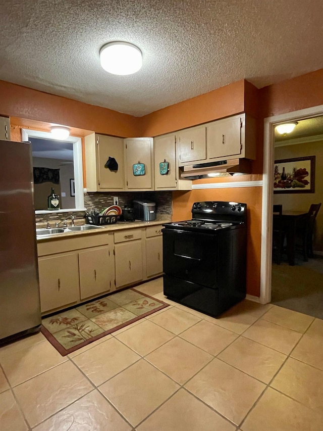 kitchen featuring stainless steel fridge, light tile floors, tasteful backsplash, and black range with electric cooktop