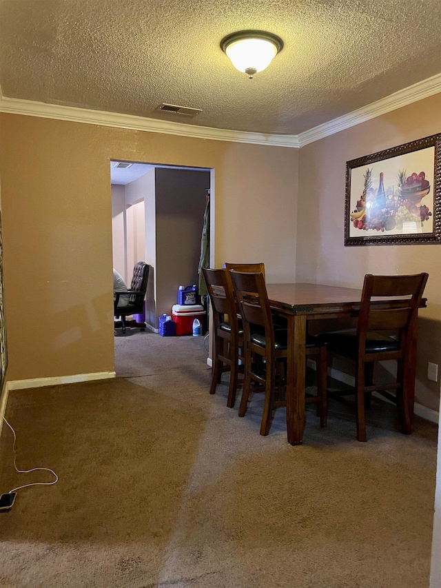 dining space featuring ornamental molding, a textured ceiling, and dark carpet