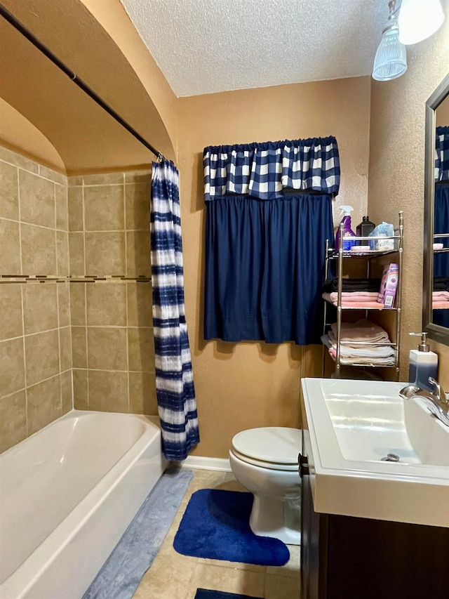 full bathroom featuring vanity, shower / bath combo, tile floors, a textured ceiling, and toilet