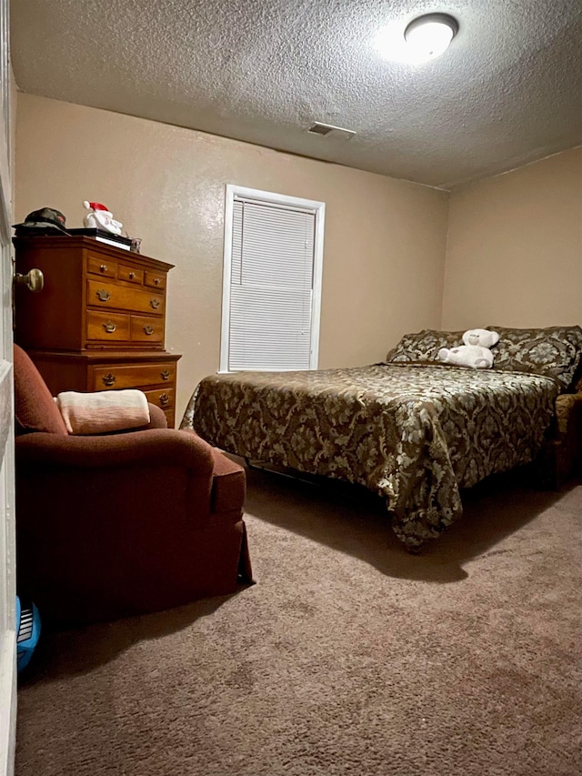 bedroom featuring a textured ceiling and carpet